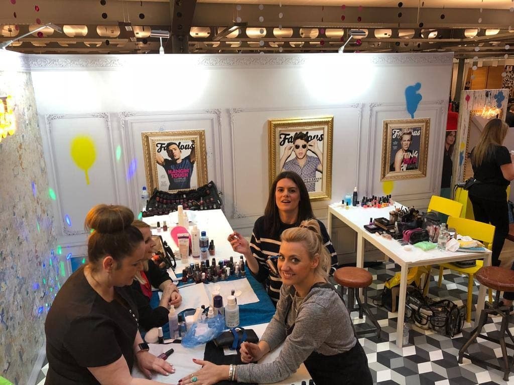 Visitors meeting at an exhibition stand with branded displays